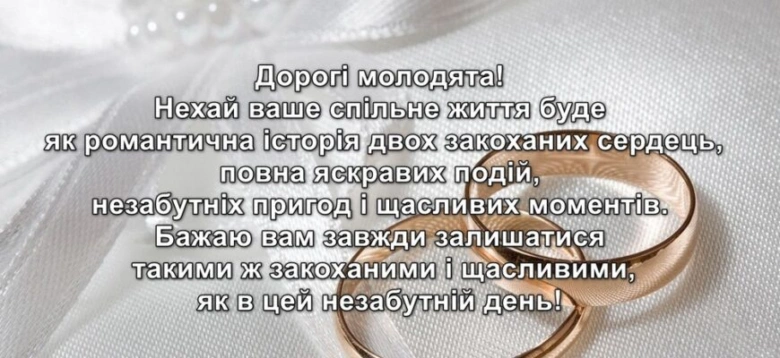 Два золоті обручальні кільця на білому фоні з привітанням.