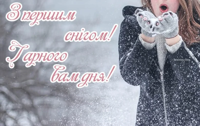 Дівчина дме сніг у рот на фоні зимового пейзажу.