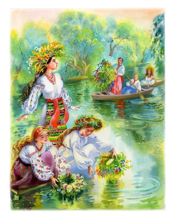 Українки в народних костюмах святкують Івана Купалу на річці.